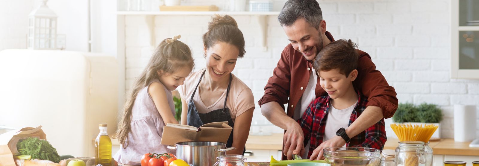 Parents and two young kids on couch at home.